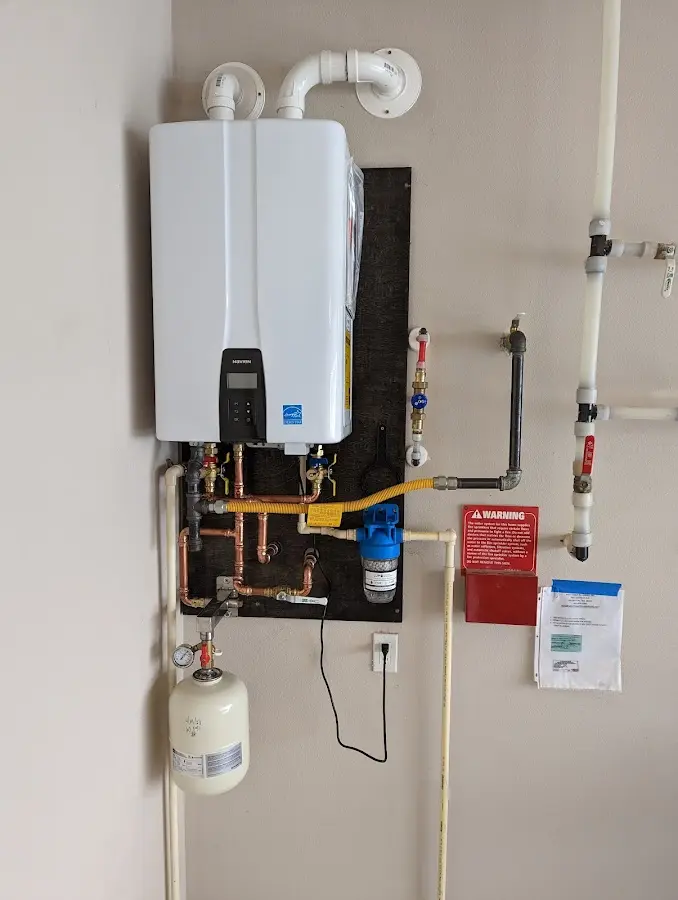 Professional plumber installing copper piping in a Conroe home